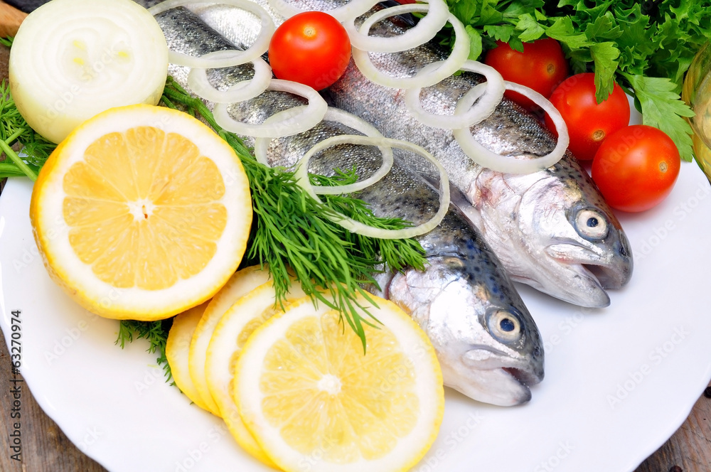 two rainbow trout with lemon and fresh vegetables two rainbow trout with lemon and fresh vegetables