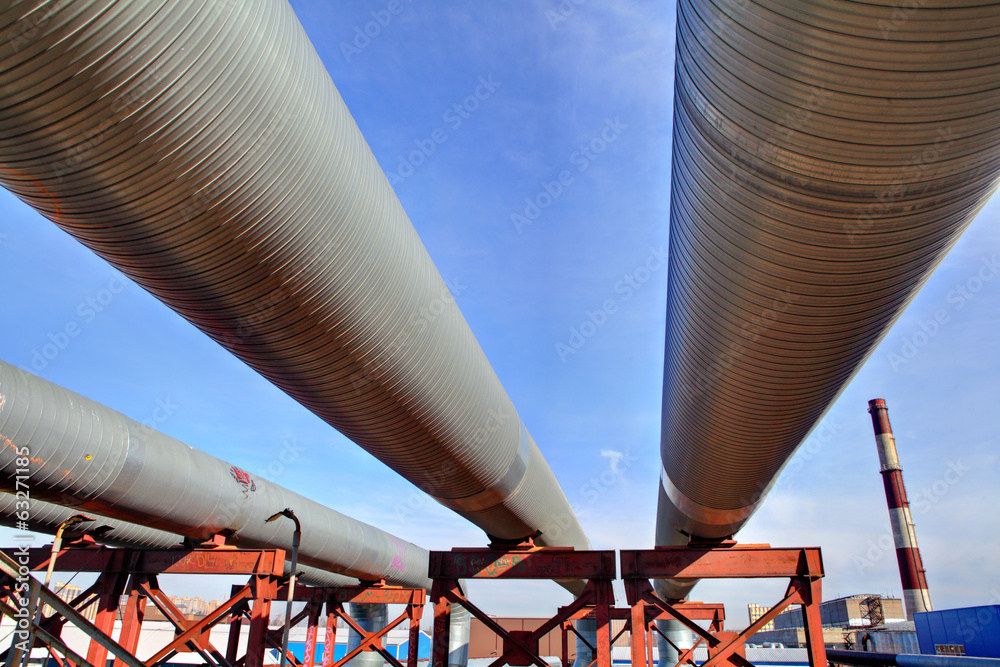 above-ground pipeline, lower shot against blue sky - obrazy, fototapety, plakaty 