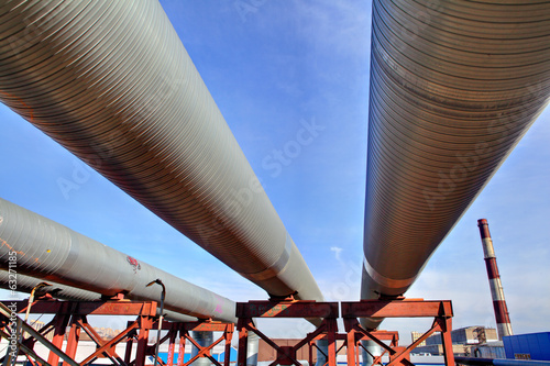 above-ground pipeline, lower shot against blue sky