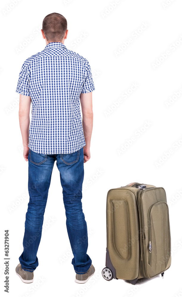 Back view of young man traveling with suitcas.
