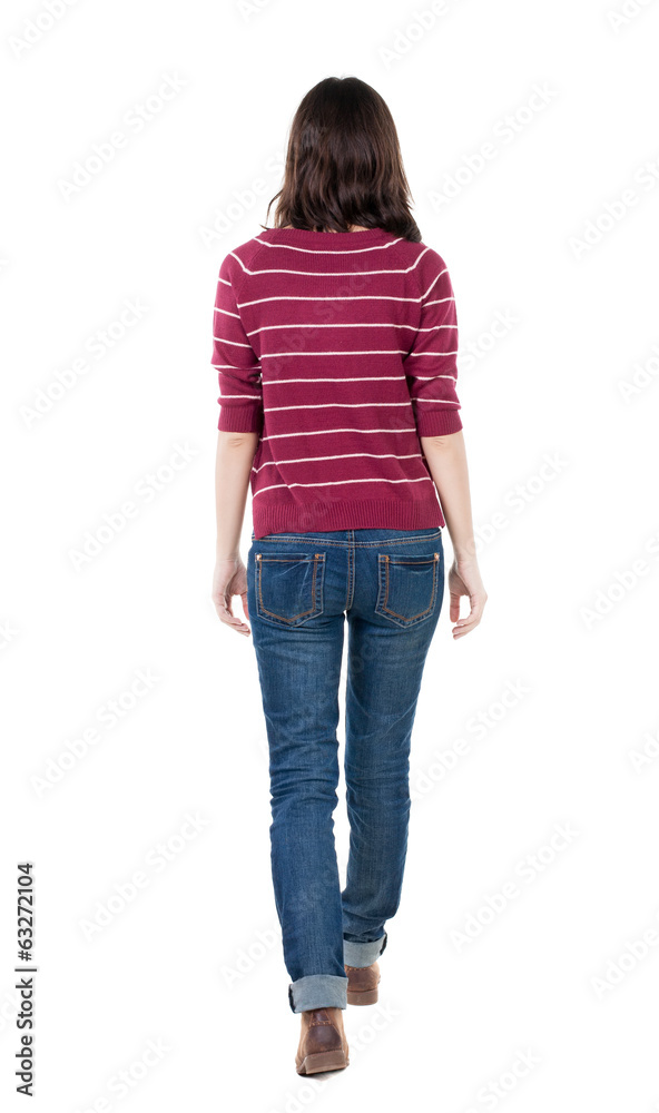 back view of walking woman in striped sweater. back view of walking woman in striped sweater.