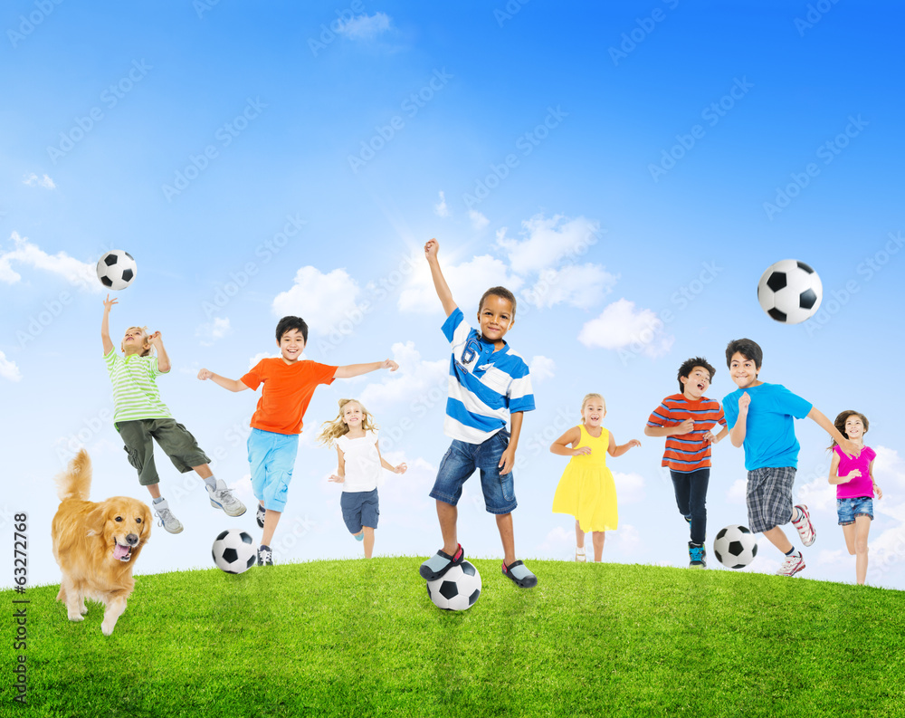 Multi-Ethnic Children Playing Soccer Outdoors