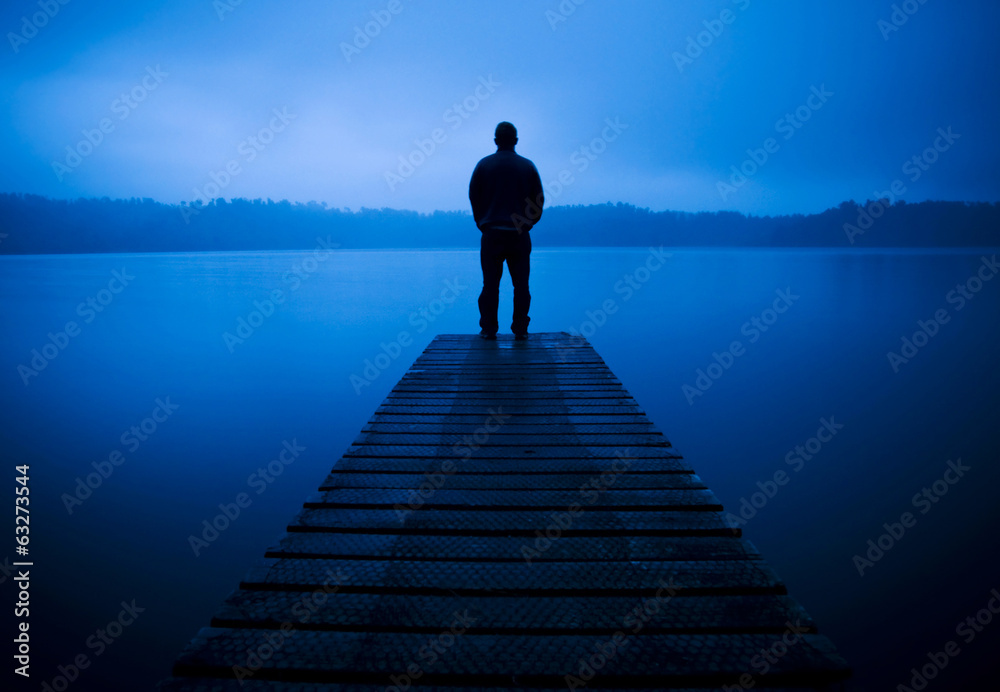 Man Standing on a Jetty by Tranquil Lake - obrazy, fototapety, plakaty 