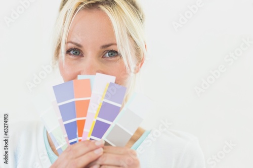 Closeup portrait of a beautiful woman holding color swatches