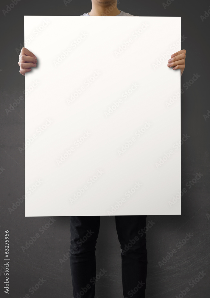 hipster holding blank poster on texture wall as concept hipster holding blank poster on texture wall as concept