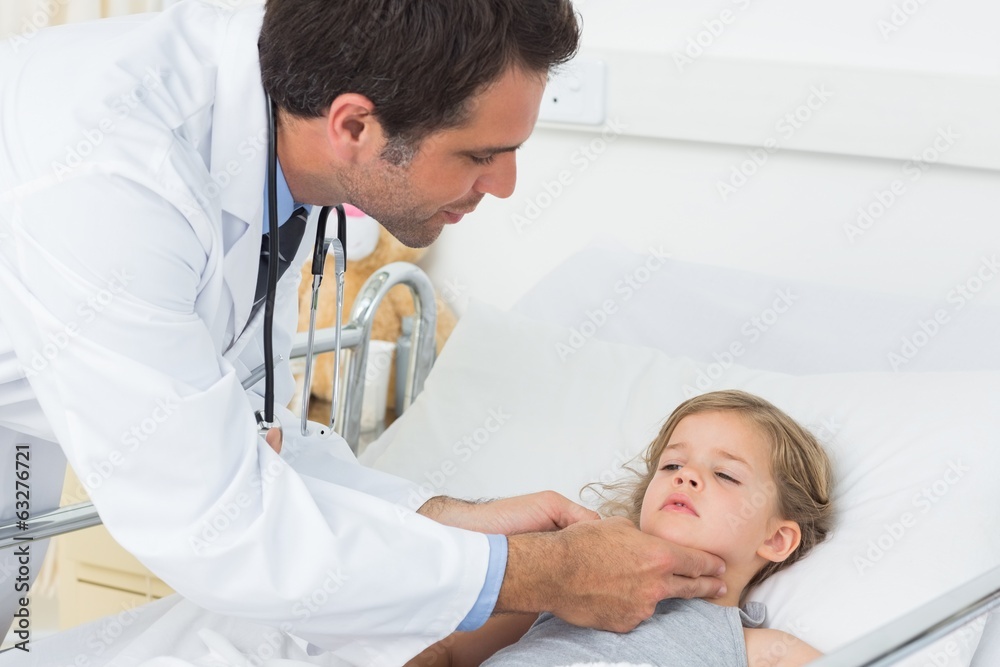 Doctor checking thyroid glands of sick girl Doctor checking thyroid glands of sick girl