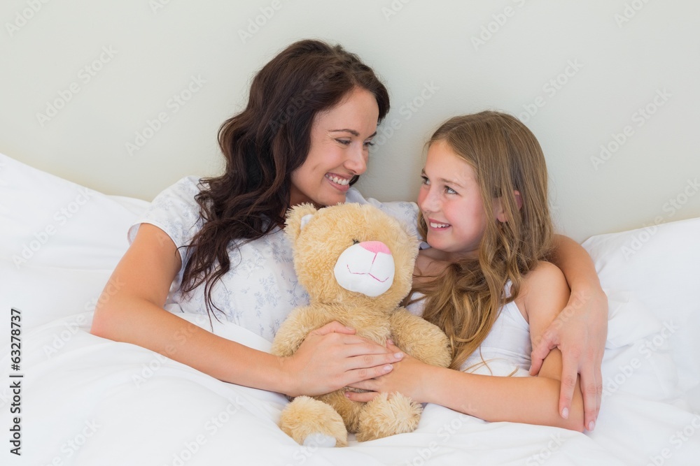 Mother and daughter with teddy bear in bed Mother and daughter with teddy bear in bed
