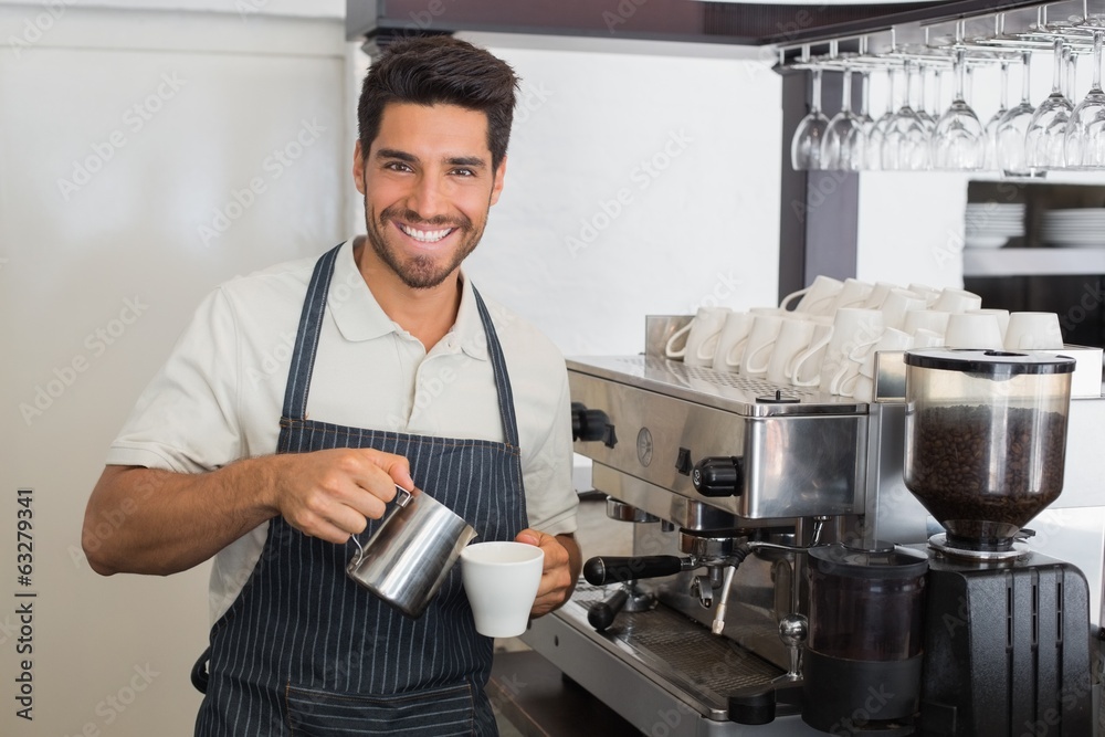 Waiter smiling and making cup of coffee at coffee shop Waiter smiling and making cup of coffee at coffee shop