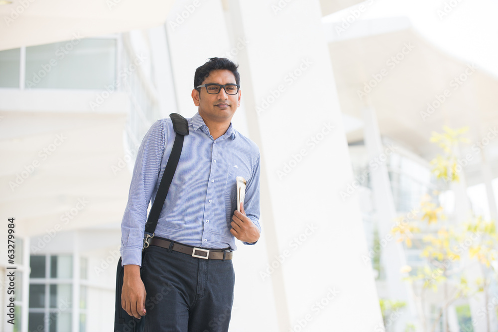 Fototapeta premium indian business male reading paper and walking