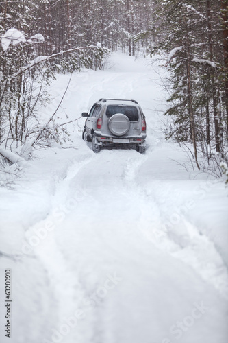 Offroad riding with deep trucks in snowy road © Kekyalyaynen