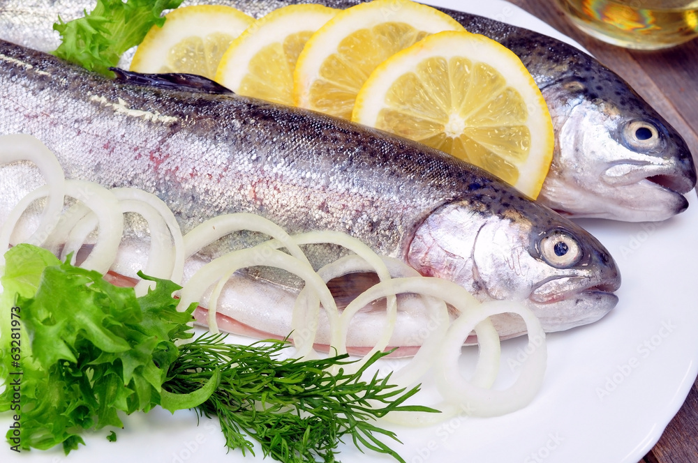 two rainbow trout with lemon and fresh vegetables
