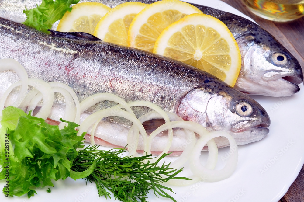two rainbow trout with lemon and fresh vegetables two rainbow trout with lemon and fresh vegetables