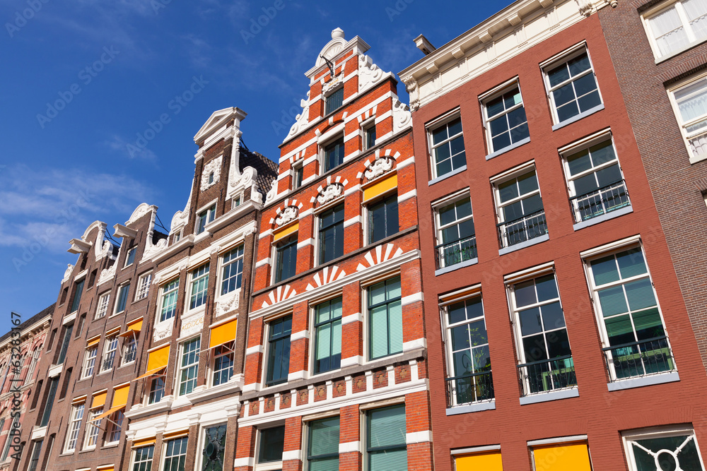 Fototapeta premium Colorful houses facades in sunny day above blue sky. Amsterdam