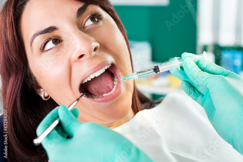 Giving anesthesia to the patient before dental surgery