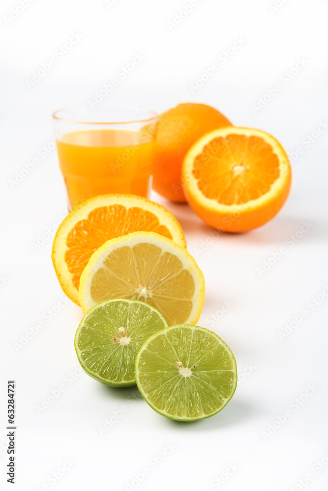 Orange juice and slices of orange and lemonade isolated on white Orange juice and slices of orange and lemonade isolated on white