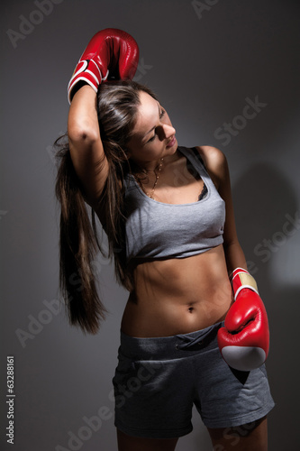 Young beautiful tired woman during fitness and boxing