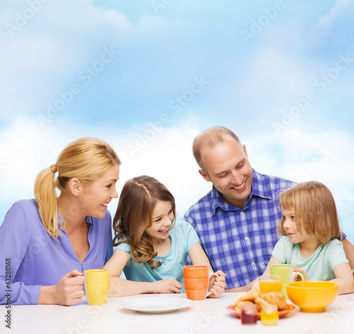 happy family with two kids with having breakfast