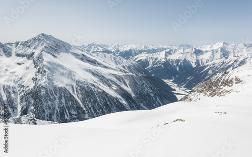 Alpine valley surrounded with mountains photo