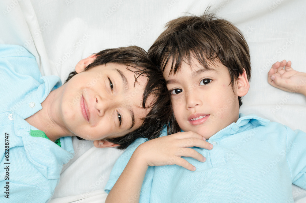 Little sibling boy laying down on the bed Little sibling boy laying down on the bed