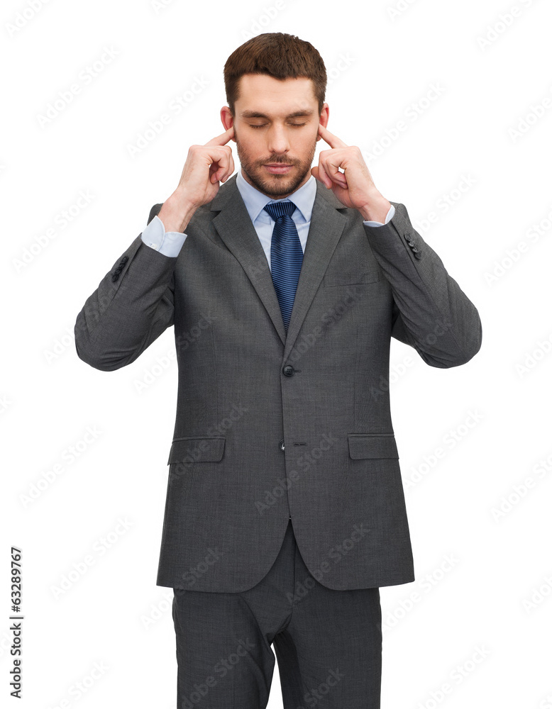 annoyed businessman covering ears with his hands annoyed businessman covering ears with his hands