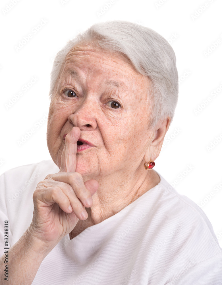 Old woman with finger on lips asking for silence Old woman with finger on lips asking for silence
