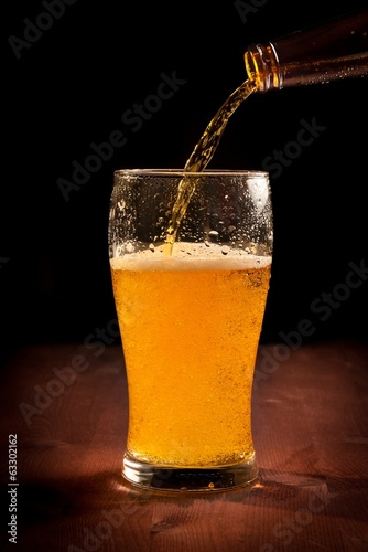 Wallpaper Mural fresh beer pouring from bottle into glass Torontodigital.ca