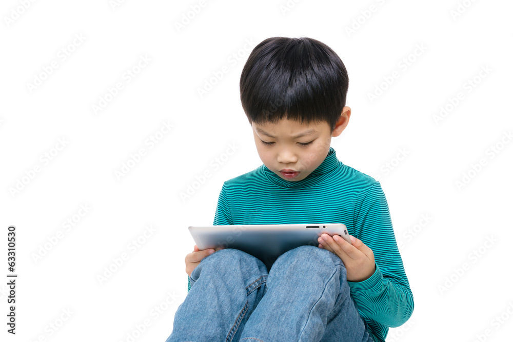 Asian little boy using tablet isolated on white Asian little boy using tablet isolated on white