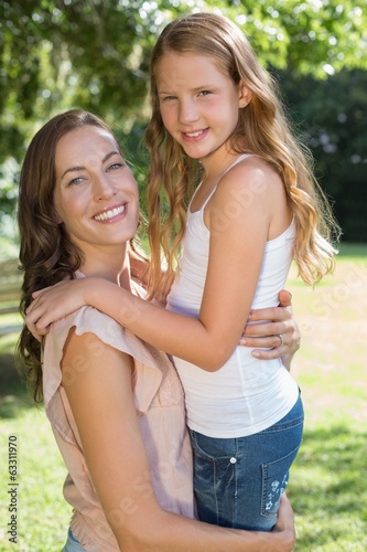 Portrait of a smiling girl and mother at park