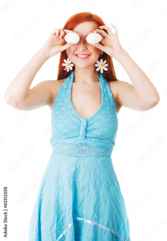 The girl holds chicken white eggs, at the level of the eyes.. The girl holds chicken white eggs, at the level of the eyes..