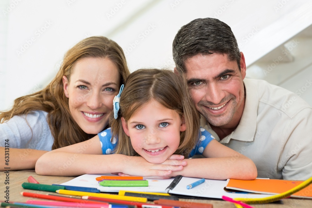 Family with book and crayons sitting at table Family with book and crayons sitting at table