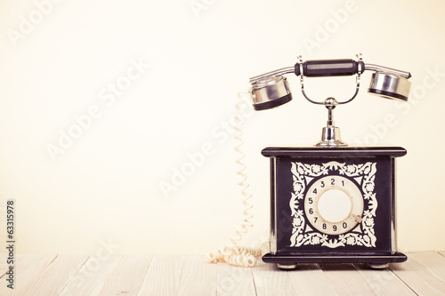 Vintage style telephone on wooden table