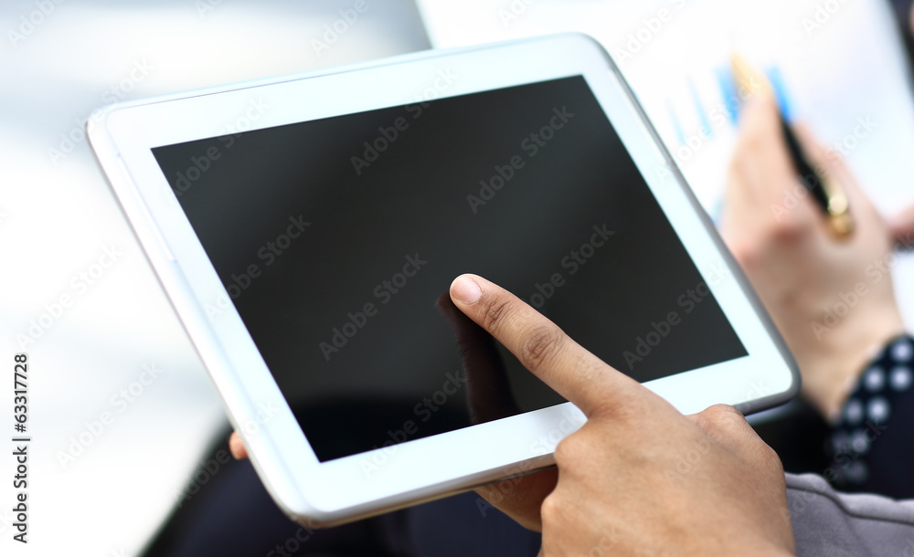 woman hand touching screen on modern digital tablet pc woman hand touching screen on modern digital tablet pc