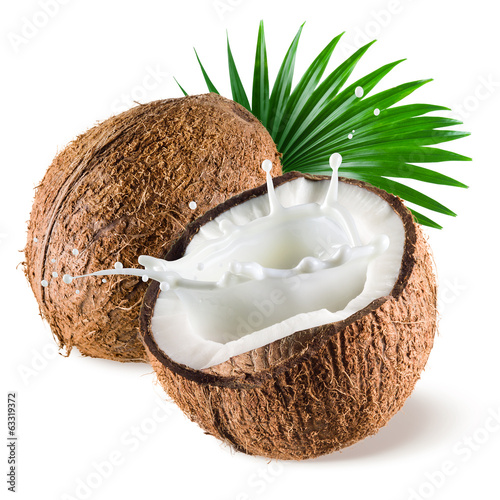 Coconut with milk splash and leaf on white background