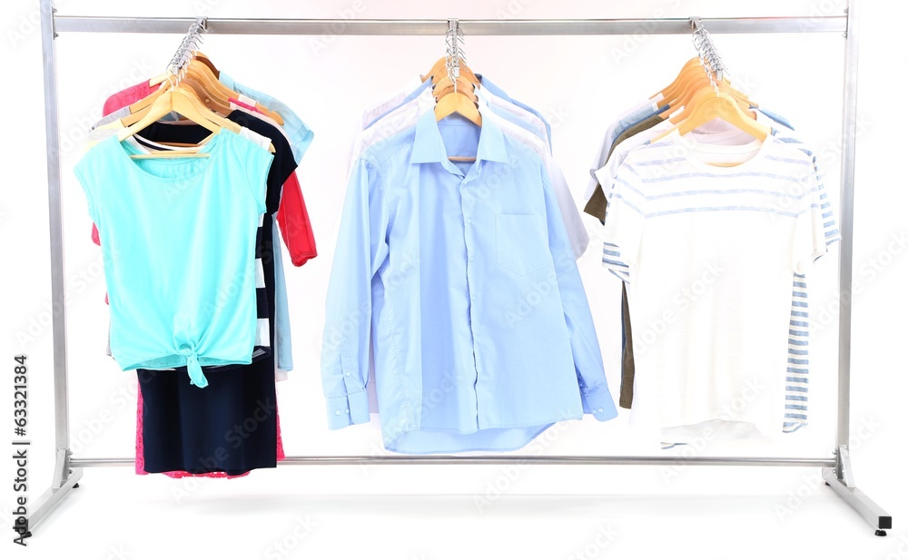 Different clothes on hangers, on gray background Different clothes on hangers, on gray background