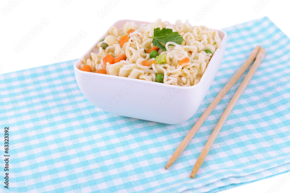 Tasty instant noodles with vegetables in bowl on table close-up Tasty instant noodles with vegetables in bowl on table close-up