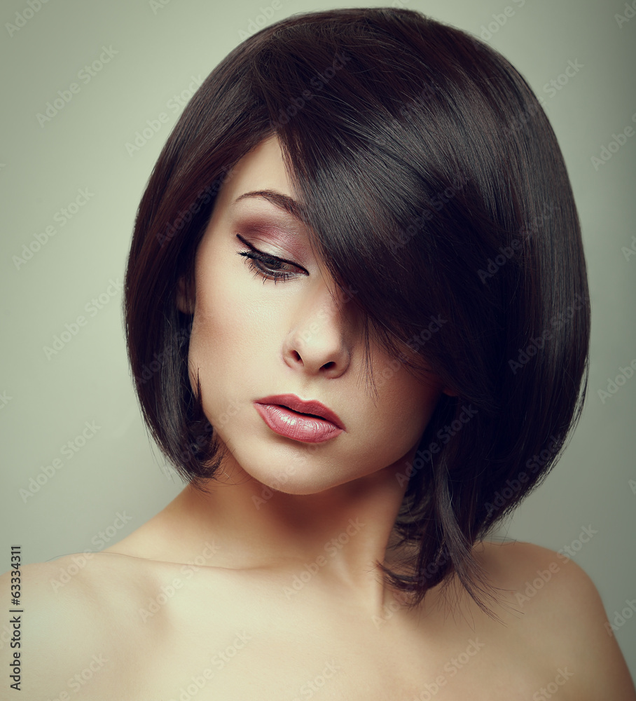 Art portrait of short hair woman looking down. Closeup