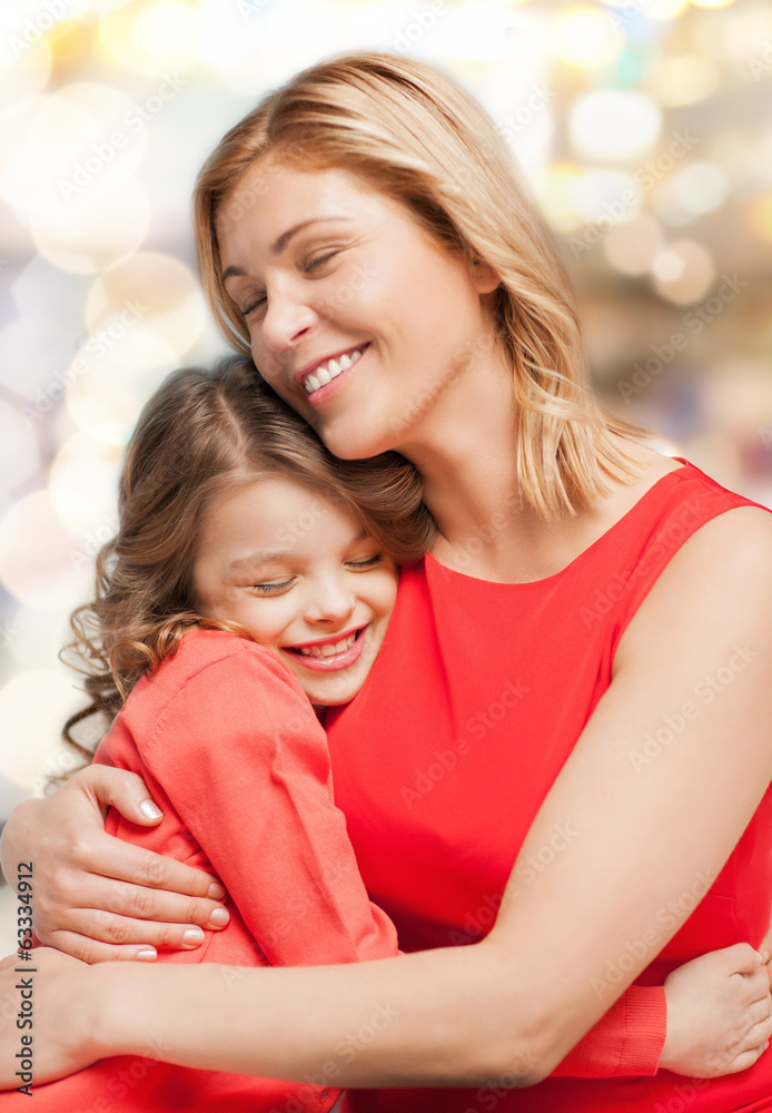 smiling mother and daughter hugging smiling mother and daughter hugging