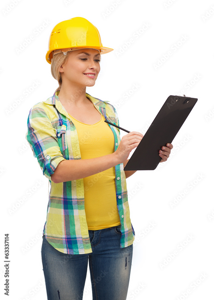 smiling woman in helmet with clipboard smiling woman in helmet with clipboard