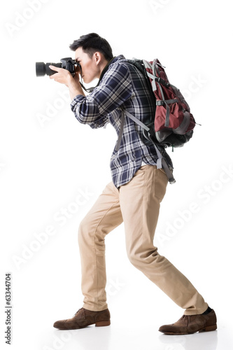 Obraz na plátně Asian young male backpacker take a picture