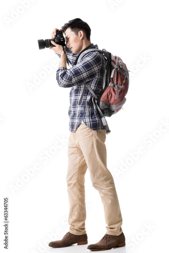 Asian young male backpacker take a picture