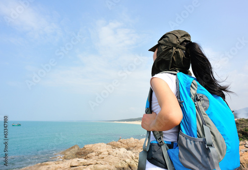   woman hiker enjoy the view at  seaside photo