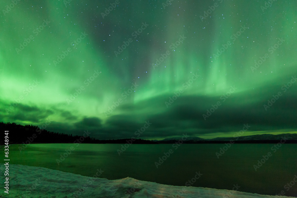 Aurora borealis night sky over frozen Lake Laberge
