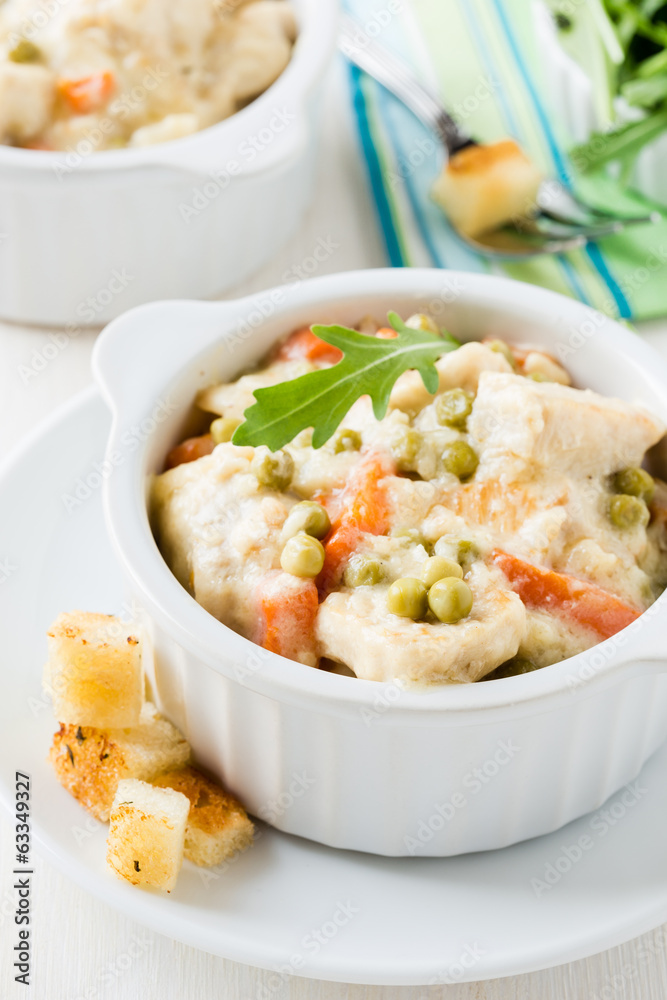 Chicken stew with carrrot and green peas in a creamy sauce Chicken stew with carrrot and green peas in a creamy sauce
