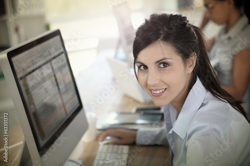 Cheerful young woman attending business training