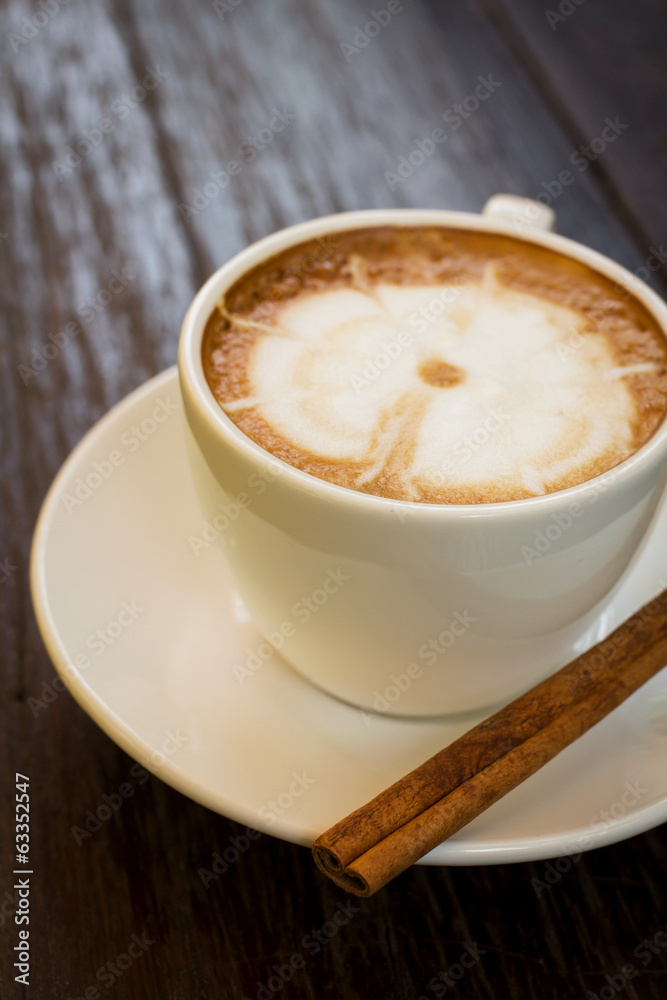 Coffee cup with cinnamon stick.