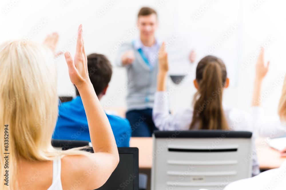 © adam121 - female hand raised in class © adam121 - female hand raised in class