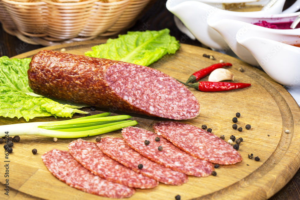 sausage on a wooden plate in a restaurant sausage on a wooden plate in a restaurant