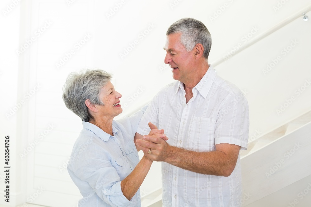 Cheerful senior couple dancing together Cheerful senior couple dancing together