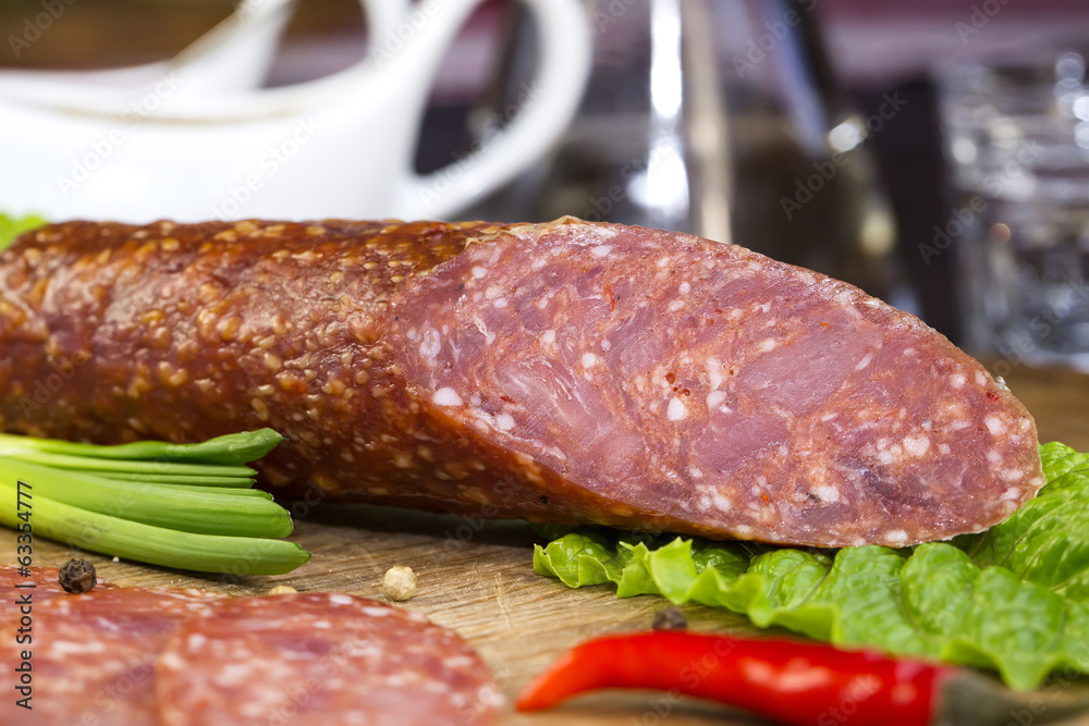 sausage on a wooden plate in a restaurant sausage on a wooden plate in a restaurant