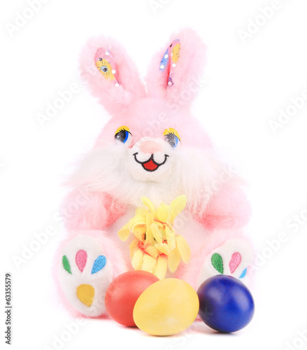 Pink toy rabbit with easter eggs.